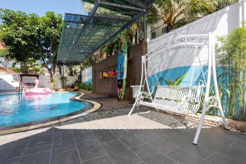 a pool with a swing and a swimming pool at Minh Phước Villa 12 Kim Ngân in Vung Tau