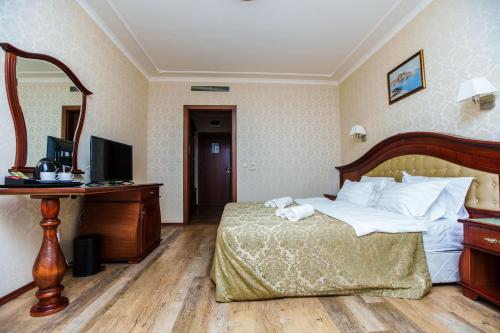 a hotel room with a bed and a desk at Aqua View SPA Boutique Hotel in Golden Sands