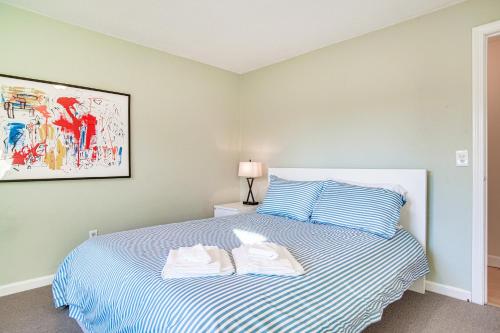 a bedroom with a bed with towels on it at Chatham Home with Spacious Deck 2 Mi to Beaches! in Chatham