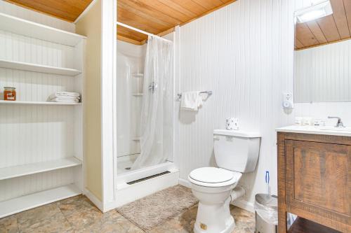 a white bathroom with a toilet and a shower at Chatham Home with Spacious Deck 2 Mi to Beaches! in Chatham