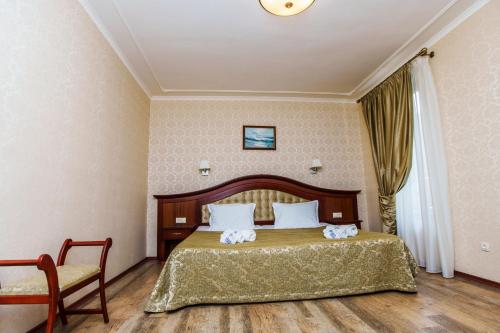 a hotel room with a bed and a chair at Aqua View SPA Boutique Hotel in Golden Sands