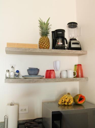 a kitchen with a counter with bananas and a pineapple at Villas VR Beachwalk Avellanas in Playa Avellana