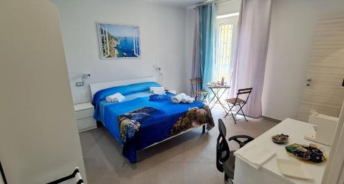 a bedroom with a blue bed and a table at Bn'b Diva in Naples