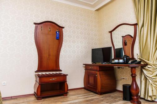 a room with a desk and a mirror and a desk with a computer at Aqua View SPA Boutique Hotel in Golden Sands