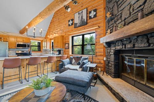a kitchen and living room with a stone fireplace at The Great Escape by Simple Life Rentals in Sister Bay
