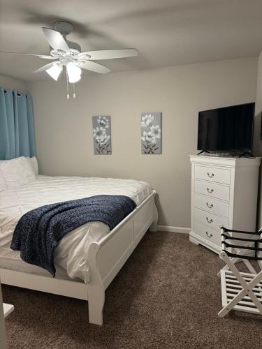 a bedroom with a bed and a flat screen tv at Business Ready 2 Kings Private Office in Lake Charles