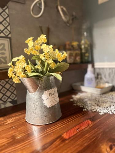 a vase filled with yellow flowers on a table at Apartment Oliver in Calella