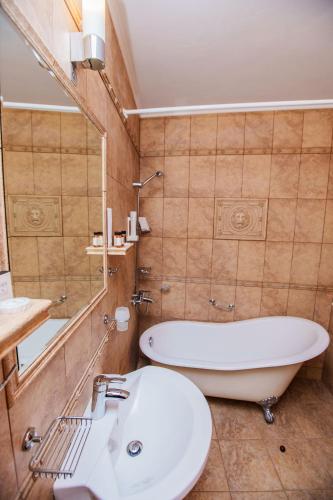 a bathroom with a tub and a toilet and a sink at Aqua View SPA Boutique Hotel in Golden Sands