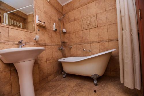 a bathroom with a bath tub and a sink at Aqua View SPA Boutique Hotel in Golden Sands