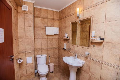a bathroom with a toilet and a sink at Aqua View SPA Boutique Hotel in Golden Sands