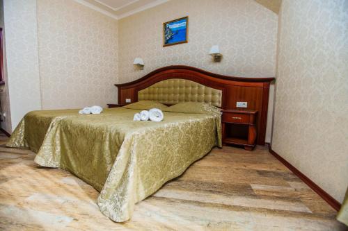 a bedroom with a bed with two towels on it at Aqua View SPA Boutique Hotel in Golden Sands