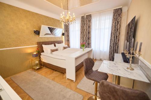 a living room with a white couch and a table at Sophie's Place Augarten - Lifestyle City Apartments Vienna Parking in Vienna