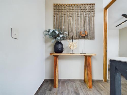 a room with a table with a vase on it at Casa Xaman in Tulum - TH 5 in Tulum