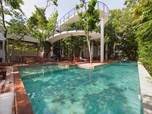 a swimming pool with a bridge over it at Casa Xaman in Tulum - TH 5 in Tulum