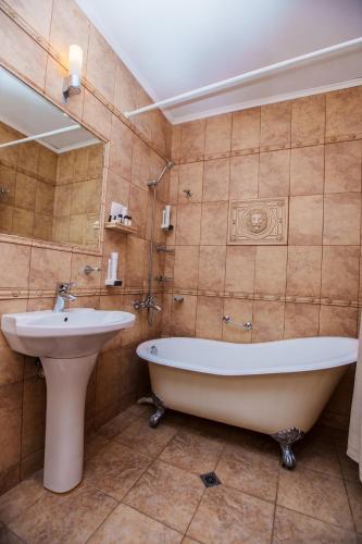a bathroom with a tub and a sink at Aqua View SPA Boutique Hotel in Golden Sands