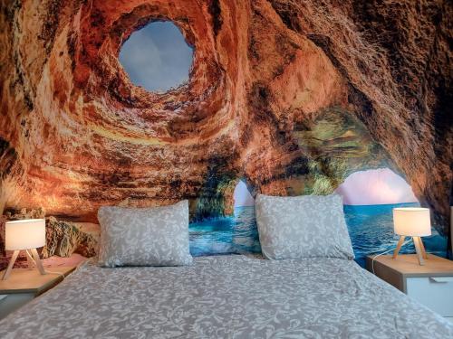 a bedroom with a bed in a cave at Oporto Cozy Rooms in Porto