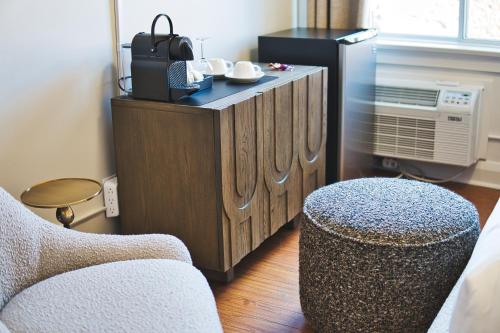 a living room with a tv and a chair at The Windsor Hotel by Hoco Hotels Collection in Stratford