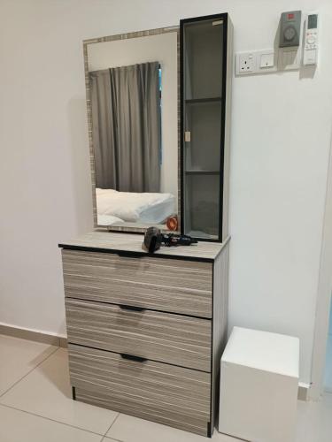 a dresser with a mirror on top of it at J Garden Village in Muar