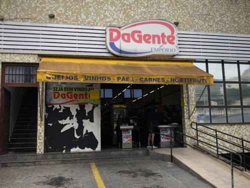 a restaurant with a sign on the front of a building at Apartamento Cidade de Deus in Osasco
