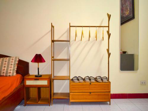 a room with a bed and two pairs of shoes at LushStay Hanoi Train Street - Cozy in Hanoi