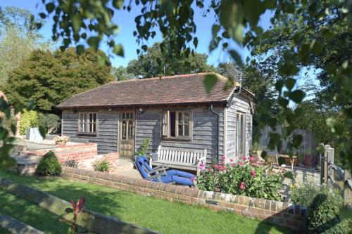 a small house with a blue couch in the yard at Deer Lodge with a View in Nuthurst