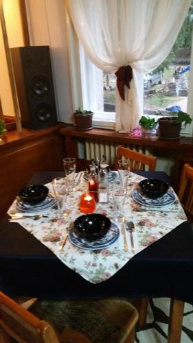 a table with plates and glasses on top of it at Boeritza Hotel Complex in Vladaya