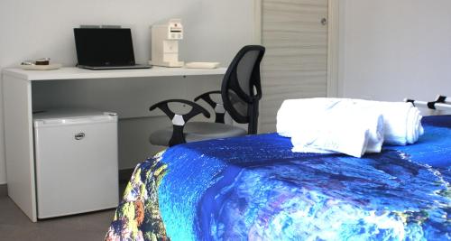 a bedroom with a bed with a desk and a chair at Bn'b Diva in Naples