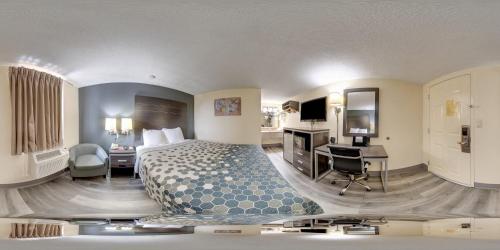 a hotel room with a bed and a desk and a room at Econo Lodge Kingsport East in Kingsport