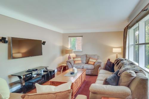 a living room with a couch and a tv at Royal Oak Home 13 Mi to Downtown Detroit in Royal Oak