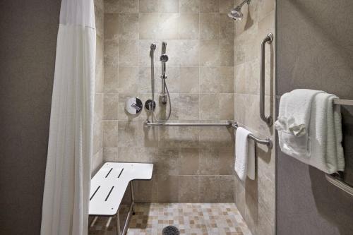 a bathroom with a shower with a shower curtain at Andell Inn in Kiawah Island