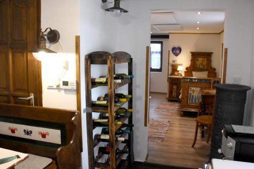 a room with a bunch of wine bottles on a wall at NAP-HOLD Vendégház in Pusztavám