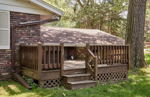 a porch with a wooden railing next to a tree at Fun-tana by Simple Life Rentals in Lake Geneva