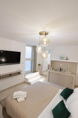 a bedroom with a large bed and a flat screen tv at Dimora in Cortile in Manfredonia