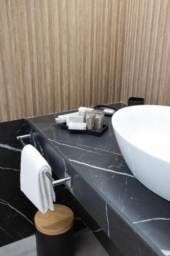 a bathroom with a white sink and a black counter at Dimora in Cortile in Manfredonia