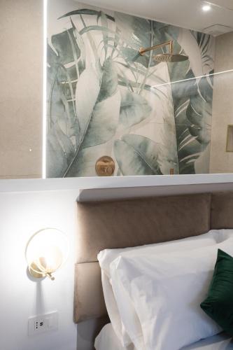 a bedroom with a painting on the wall next to a bed at Dimora in Cortile in Manfredonia