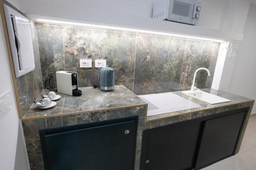 a bathroom with a counter with a sink and a sink at Dimora in Cortile in Manfredonia