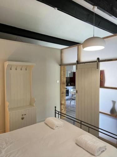 a bedroom with a bed with two pillows on it at Richmond Hill Cottage Markington in Ingerthorpe