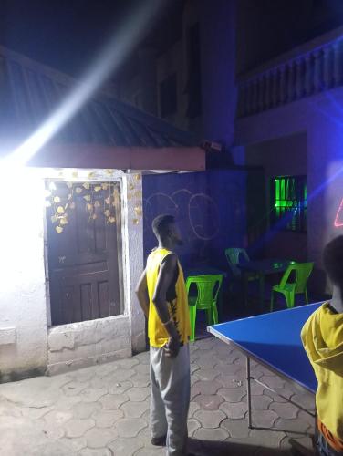 a man standing in front of a ping pong table at Crale N Busino Hotel & Lounge in Elelenwa