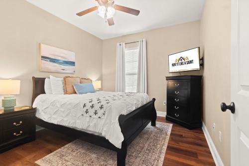 a bedroom with a bed and a ceiling fan at Tailored For Work Groups At Thibs Crib in Lake Charles