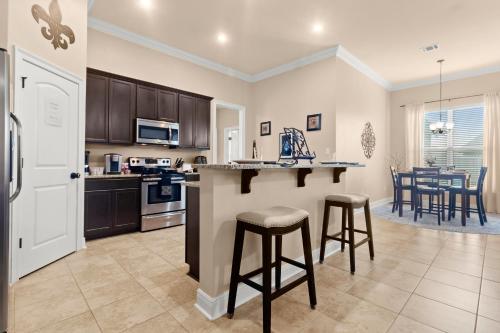 a kitchen with a counter and some stools in it at Tailored For Work Groups At Thibs Crib in Lake Charles