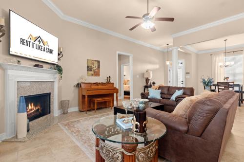 a living room with a couch and a fireplace at Tailored For Work Groups At Thibs Crib in Lake Charles