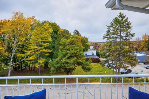 a balcony with a view of a yard with trees at Bluff Haven by Simple Life Rentals in Fish Creek