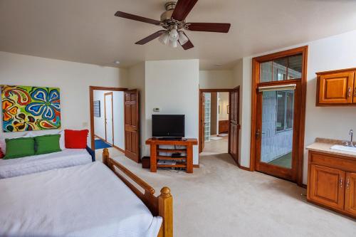 a bedroom with a bed and a flat screen tv at Bluff Haven by Simple Life Rentals in Fish Creek