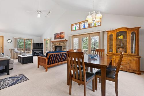 a dining room and living room with a table and chairs at Blue Skies and Cherry Pies by Simple Life Rentals in Fish Creek
