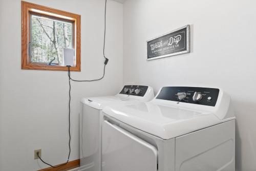 a white sink in a room with a window at Blue Skies and Cherry Pies by Simple Life Rentals in Fish Creek