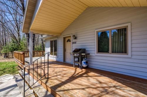 a front porch of a house with a grill at Blue Skies and Cherry Pies by Simple Life Rentals in Fish Creek