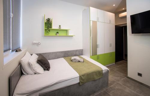 a bedroom with a large bed in a room at DORM BG pet-friendly Aparthotel in Stara Zagora