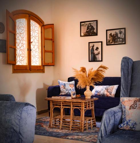 a living room with a blue couch and a table at Dar Lina Guesthouse Luxor in Luxor