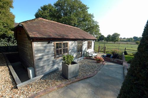 a small shed with a bench in a yard at Deer Lodge with a View in Nuthurst