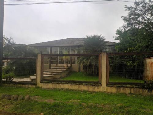 a wooden fence in front of a house at Recanto do sossego!! in Morretes